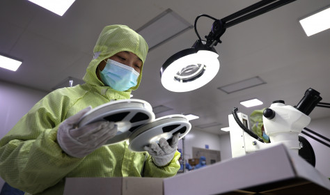 A worker produces semiconductors at a workshop of a semiconductor manufacturer in Binzhou, East China's Shandong Province.